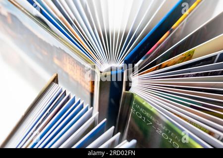 Colored spines of books lying on top of each other. Selective Focus. Stock Photo