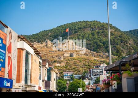 Fethiye, Turkey - June 9, 2023: View from street of old town Fethiye of ruins of antique castle, Turkey Stock Photo