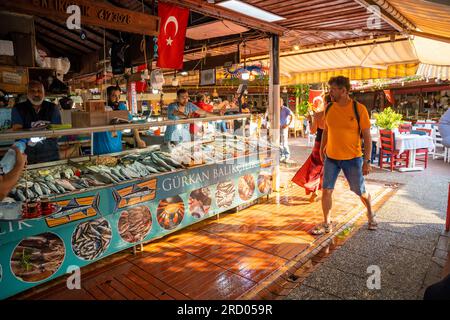 Fethiye, Turkey - June 9, 2023: People visit Fathiye Fish Market of old town with fresh seafood shops and restaurants, Turkey Stock Photo