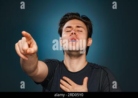 Young man pointing with finger and laughing Stock Photo