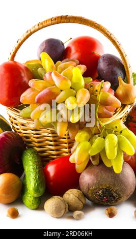 Fruits and vegetables in a basket isolated on a white background. Vertical photo. Stock Photo