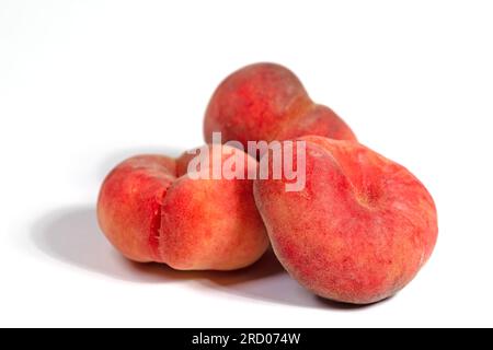 Flat peaches isolated against white background Stock Photo