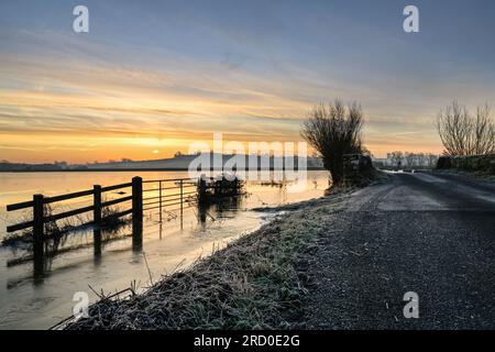 Winter Sunrise over Flooded and Frozen Somerset Levels near Highbridge and Burrow Hill Langport Somerset Stock Photo