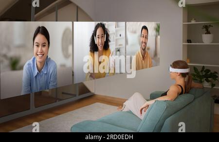 Lady Talking To People On Screens Communicating Via VR Indoor Stock Photo