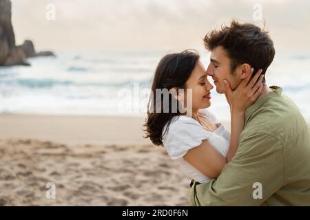 Sweet love story. Loving couple bonding and enjoying time on romantic date on the coastline, free space Stock Photo