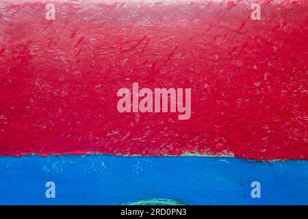 Painted red and blue fibreglass panel shot close up for use as a background, Stock Photo