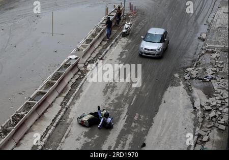 A two wheeler falls down due to the slippery road near the Red Fort as floodwater of the swollen Yamuna River recede in New Delhi. The locals and authorities carry out a cleanliness drive in flood-affected low-lying areas to minimize the waterborne diseases. Again Yamuna water level reached 205.93 metres above danger mark of 205.33 official said. The Yamuna Rover broke a 45 years record and reached its all-time highest level of 208.65 on July 2023 after heavy rainfall and release of water from the Hathnikund barrage in Haryana. Stock Photo