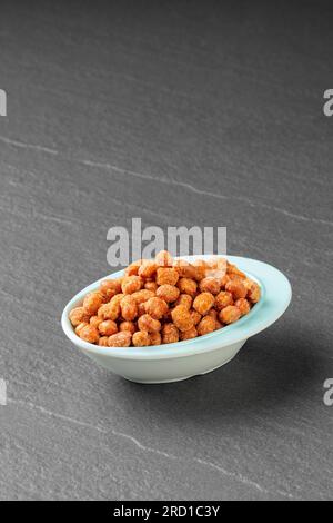 Candied peanuts, Peanuts praline sweet in a white bowl Stock Photo
