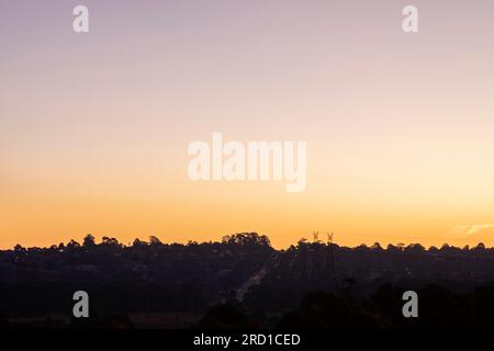 Gorgeous dusk suburban landscape revealing muntain highway. Stock Photo