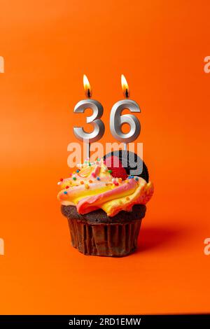 birthday cake with number 36 - cupcake on orange background with birthday candles Stock Photo