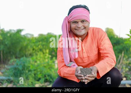 Happy Indian farmer, farmer holding soil in hands Stock Photo