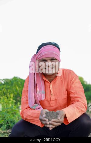 Happy Indian farmer, farmer holding soil in hands Stock Photo