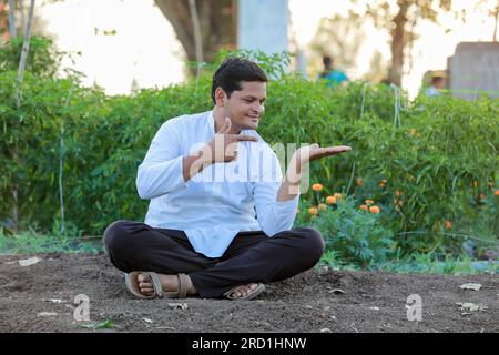 Happy Indian farmer, showing epmty hands in farm Stock Photo