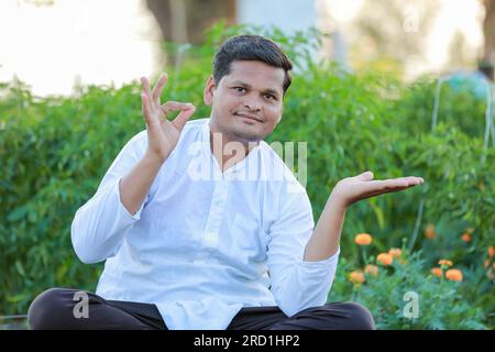 Happy Indian farmer, showing epmty hands in farm Stock Photo