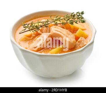 bowl of fish soup with vegetables isolated on white background Stock Photo