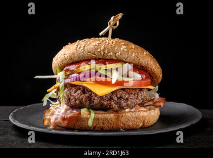 fresh tasty burger on black plate Stock Photo