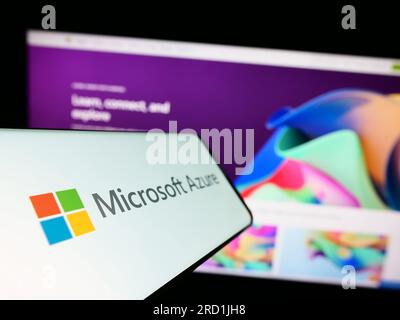 Cellphone with logo of cloud computing platform Microsoft Azure on screen in front of business website. Focus on center-left of phone display. Stock Photo