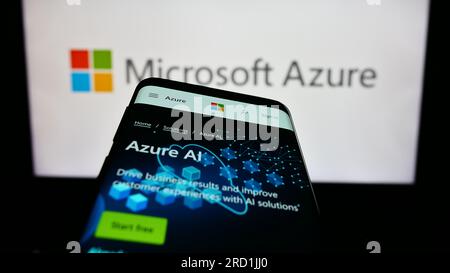 Mobile phone with webpage of cloud computing platform Microsoft Azure on screen in front of business logo. Focus on top-left of phone display. Stock Photo