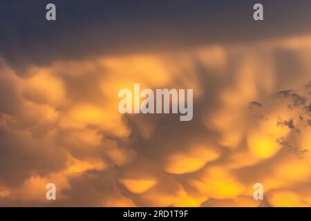 Threatening yellow clouds in a storm at sunset Stock Photo