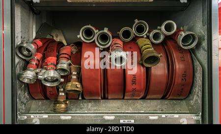 Closeup of firefighting hoses rolled up  in storage Stock Photo