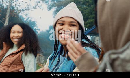 Camping, laughing and friends in conversation in nature on winter weekend trip or holiday. High five, celebration and women talking and making funny Stock Photo