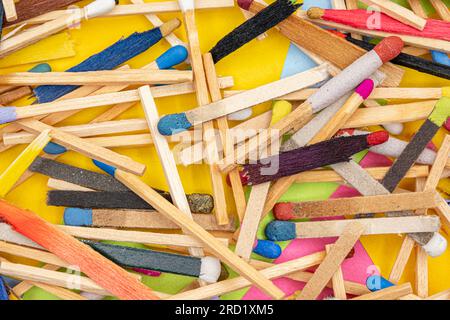 matchsticks of various shapes and colors with multicolored paper sticky notes on background Stock Photo