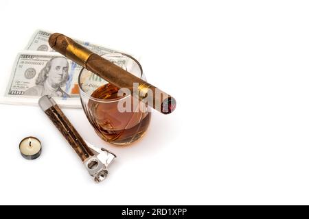 Quality cigars with cognac, cutter, light candle and 100 dollar paper Stock Photo