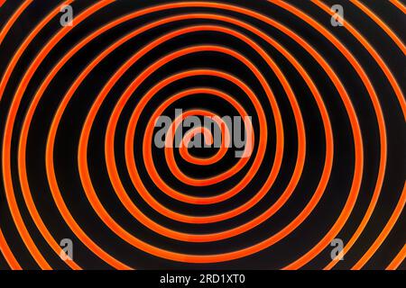 Simple orange spiral on dark background Stock Photo