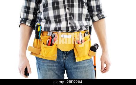 Man wearing mounting belt with tools for repair isolated on white background. Professional equipment of handyman Stock Photo