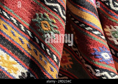 Detail of a traditional Turkish rug. Hand-woven rug and carpet motifs. The folds of the carpet and the colorful ornament details. Stock Photo