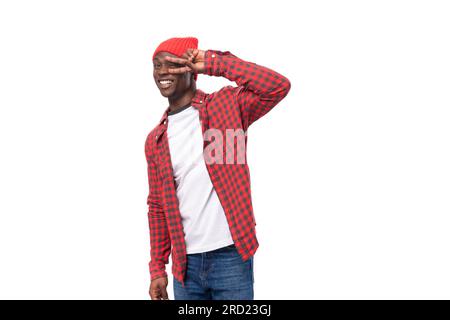 handsome embarrassed dark-skinned man in a casual plaid shirt of model appearance on a white background with copy space Stock Photo