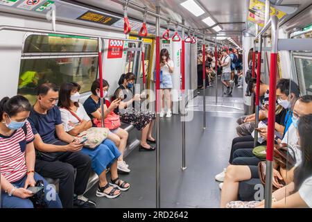 Passengers on MTR rapid transit train, Hong Kong, SAR, China Stock Photo