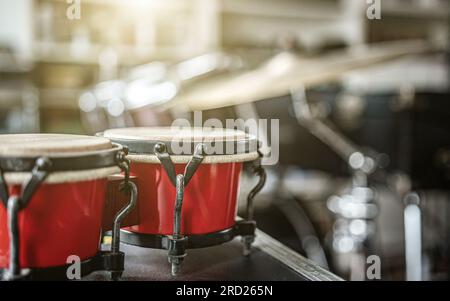 Red bongos drums in recording studio for hard beat perfomance. Professional musical instrument for rock concerts Stock Photo