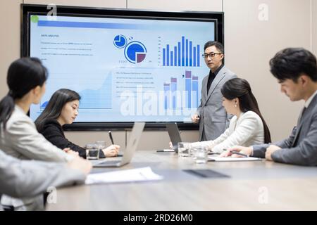 Confident Chinese business people having a meeting Stock Photo