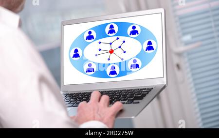 Social network concept shown on a laptop used by a man Stock Photo