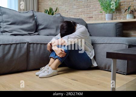 Mature woman suffering from physical pain, mental problems Stock Photo