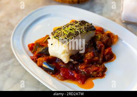 Cod confit with vegetable ratatouille on plate Stock Photo - Alamy