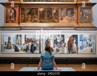 The National Gallery, London, UK. 18 July 2023. More than 30 years after Dame Paula Rego (1935-2022), the National Gallery's first Associate Artist (1990-92), was invited to create a mural for the Sainsbury Wing Dining Room, a new exhibition celebrates the relationship of one of the most ambitious of Rego's public commissions, Crivelli's Garden, to the National Gallery and its collection. The exhibition unites the monumental 10-metre-long artwork with the 15th-century altarpiece by Carlo Crivelli that inspired it (composite image with altarpiece at top). Stock Photo