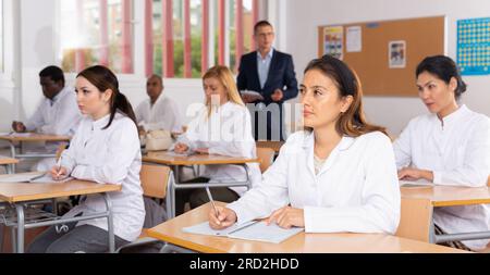 Medical students writing in notepads lesson Stock Photo