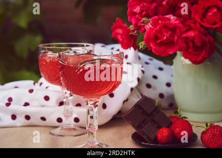 https://l450v.alamy.com/450v/2rd2htk/couple-glasses-of-red-sparkling-strawberry-wine-with-roses-outdoor-strawberry-and-chocolate-aesthetic-summer-table-settings-2rd2htk.jpg