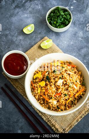 Asian Fried Rice with Condiment on Dark Background Top Down Vertical Photo Stock Photo