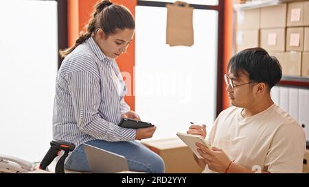 Man and woman ecommerce business workers working together at office Stock Photo