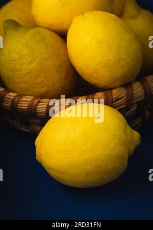 Basket with ripe lemons. On a rustic blue dark background. High quality photo Stock Photo