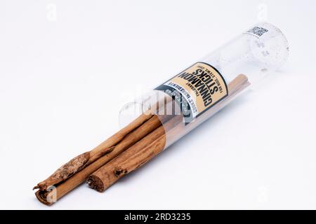 Tube of Cooks Ingredients Dried Cinnamon Sticks Spilling from Container Stock Photo