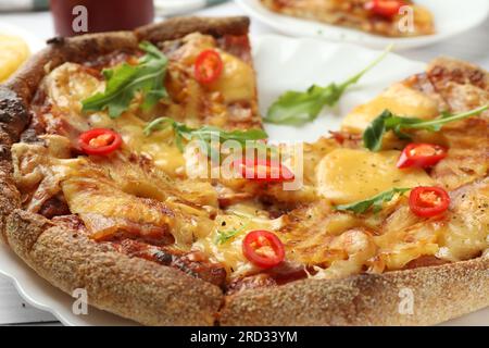 Delicious Hawaiian pizza with pineapple on table, closeup Stock Photo