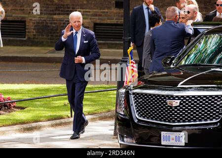 President Joe Biden waves to the media as he gets out of The Beast - The United States presidential state car, nicknamed 'the Beast', 'Cadillac One', Stock Photo