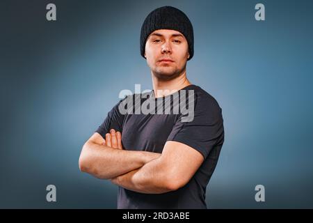 Young strong handsome man posing on gray background Stock Photo