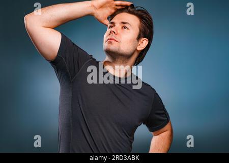 Young handsome man posing on gray background Stock Photo