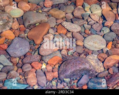 Closeup of colorful rocks in clear water on the edge of Lake Superior on the Upper Peninsula of Michigan USA Stock Photo