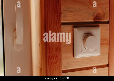 Close up electrical dimmer switch light for adjustable brightness control in wooden house Stock Photo